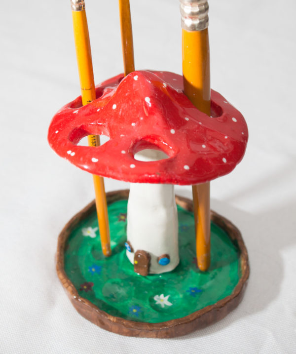 Handmade mushroom shaped holder made of clay for pens, brushes, markers, and pencils, perfect for home decor and desk organization.